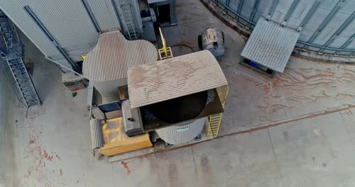 Commercial Grain Or Seed Silos In Sunny Spring Rural Landscape