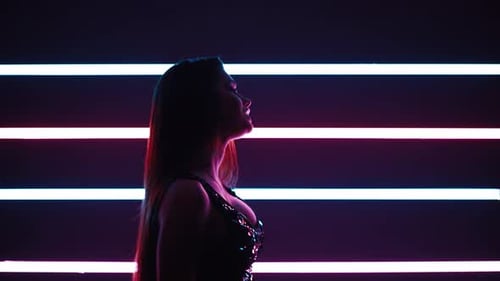 Silhouette European Woman Singer Sings a Song in the Studio for a Music Video