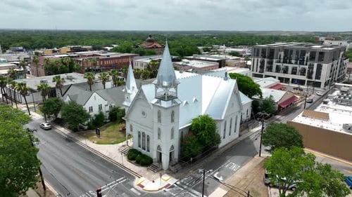 Aerial establishing shot of Christian church building and steeple in southern USA. Aerial approach.