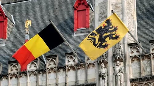 Belgian Flags Waving on Historic Stone Building