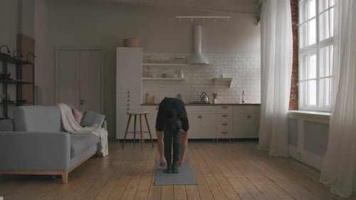 Man Doing Yoga and Stretching Indoors