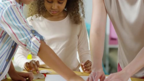 Children and Adult Creating Paper Art Together