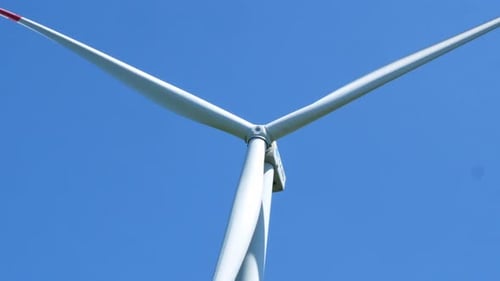 Electric windmill with long blades close-up. Wind turbine for the production of electricity.