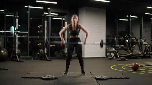 Strong Woman Athletic Female Performs Exercises with Barbell Lifts Barbell and Does Weights Crossfit