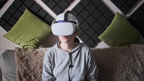 Woman Using Virtual Reality Headset on Couch