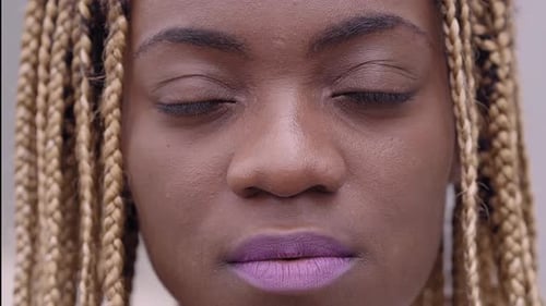 Closeup of a Portrait of a Young African Woman Looking at the Camera Seriously