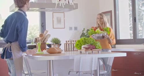 Couple Prepares Colorful Salad in Modern Kitchen