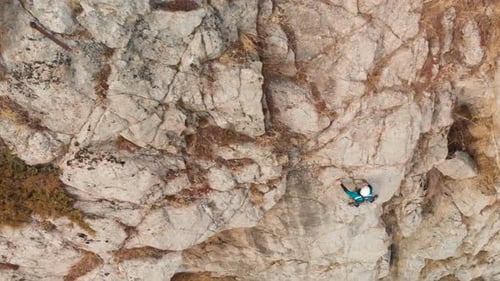 Man Athlette Climbing on the High Rock