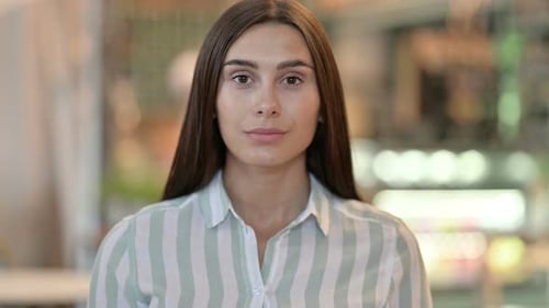 Woman's Portrait with Brown Hair and Neutral Expression