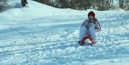 Happy Child Enjoying Winter Sledding Outdoors