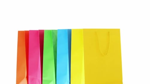 Row of Colorful Shopping Bags on White Background
