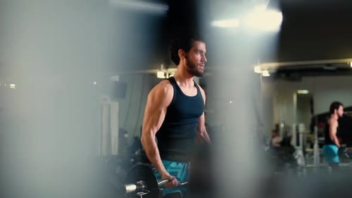 Man Doing Bicep Curls at the Gym