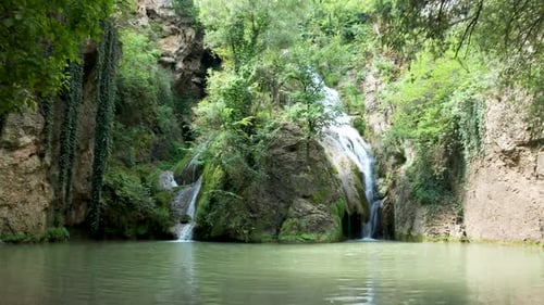 Beautiful Waterfall Flowing into a Calm Pool