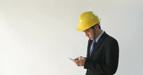 Adult Man in Suit Using Smartphone