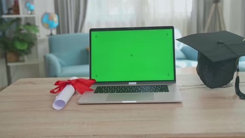 Graduation Cap And Diploma With Mock Up Green Screen Laptop Computer