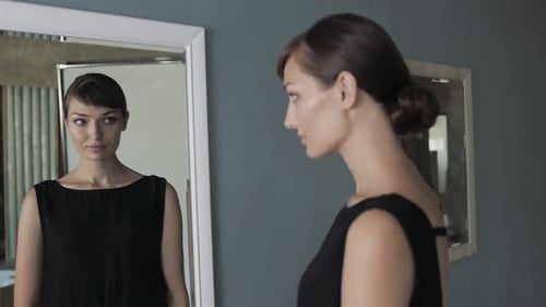 Woman Posing in Black Dress Looking in Mirror