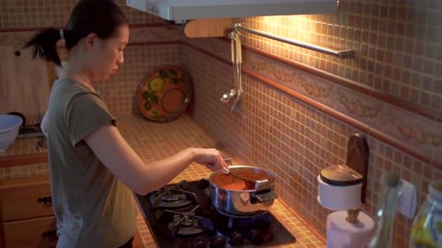 Woman Cooking Food in the Kitchen