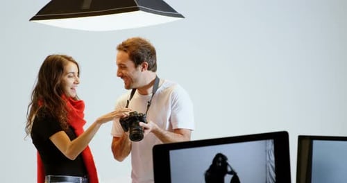 Photographer and Model Reviewing Photos in Studio