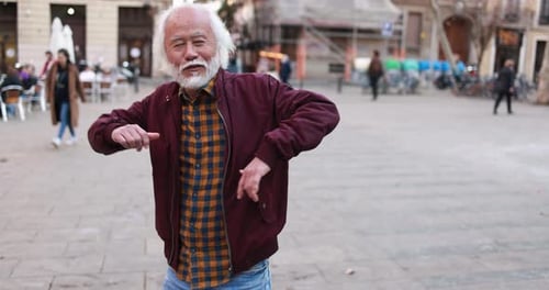 Senior Man Dances in European City Square