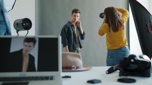 People Model and Photographer in Studio During Photoshoot Working Indoors