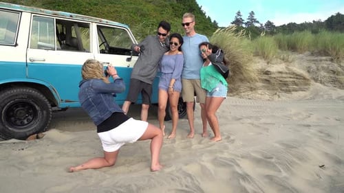 Group of friends at beach taking photos together