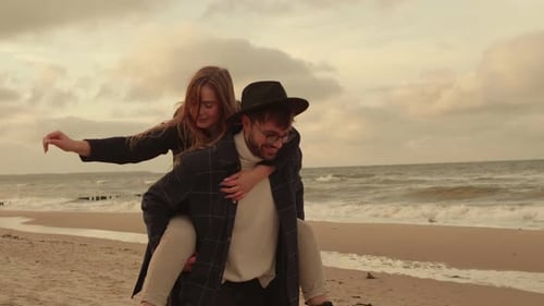 Young Couple Having Fun By the Sea
