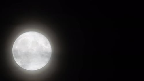 Full Moon Shines in Dark Night Sky
