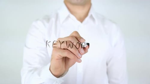 Man Writes the Word Keyword on Glass