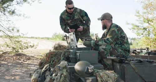 Army Commander Sits Behind Computer in Field and Creates Reports to Be Sent to Army Base Man