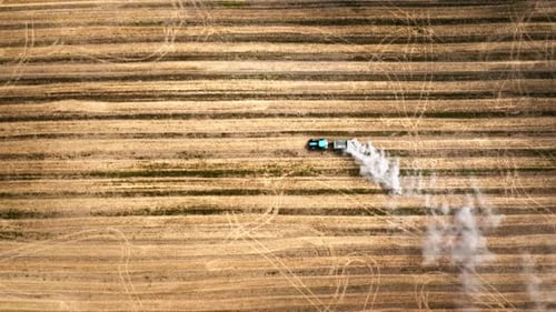 Top down view of tractor plowing a field in autumn