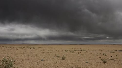 Dark Storm Clouds Over The Vast Arid Desert