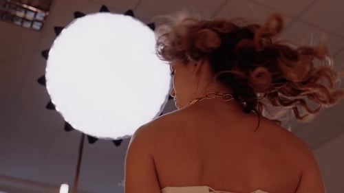 Elegant Young Woman Posing in Studio Setting