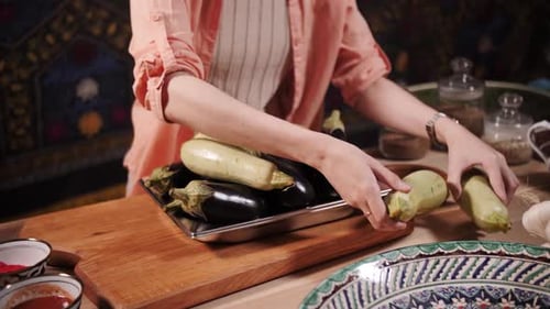 Woman Arranges Vegetables on a Tray in Kitchen