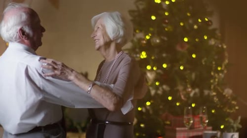 Senior Couple Dancing Happily at Christmas at Home