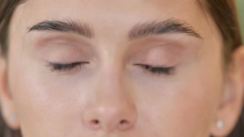 Close Up of Blinking Eyes of Beautiful Young Woman