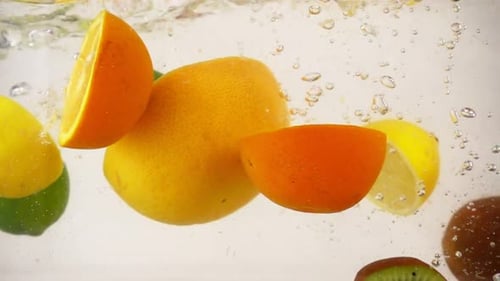 Vibrant Citrus Fruit Slices Splashing into Water