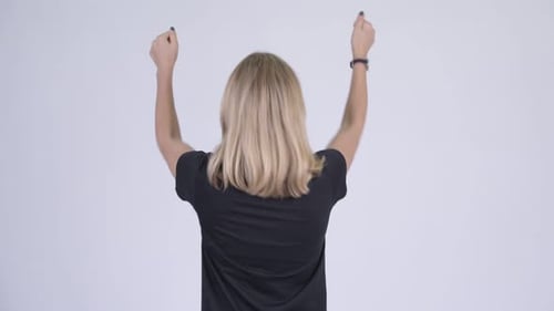 Rear View of Young Happy Blonde Woman with Fists Raised