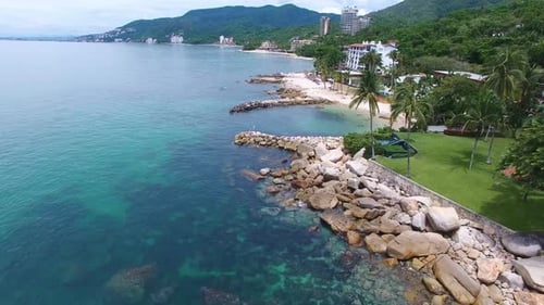 Tropical Shoreline with Rocks and Clear Ocean Water