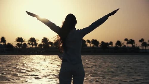 Woman Stretching on Tropical Beach at Sunset
