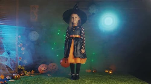 Charming Girl Celebrates Halloween Dressed as a Witch