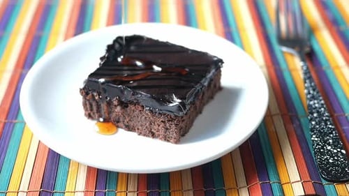 Syrup Poured onto Chocolate Brownie Cake Slice
