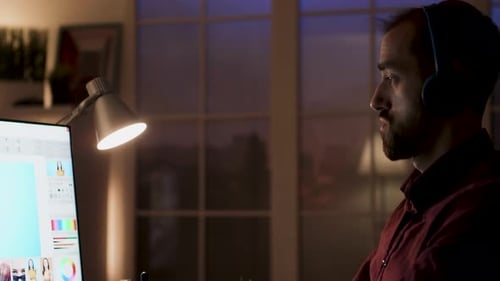 Young Man Working at Computer Late at Night