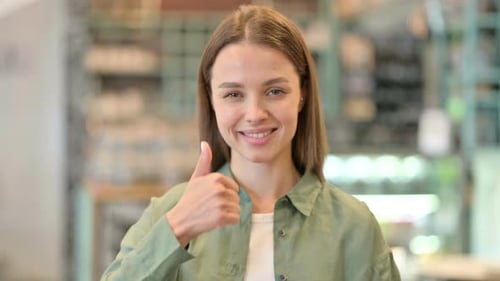 Smiling Woman Gives Thumbs-Up Approval Close-Up