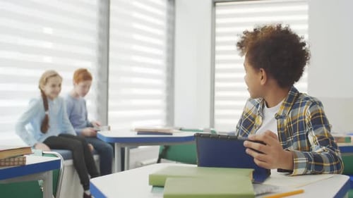 Classmates Using Tablet during Break