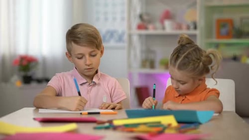 Children Drawing with Markers at Table Indoors