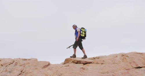 Senior Adult Hiking Desert Mountain with Backpack