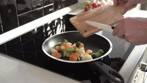 Adult Cooking Colorful Vegetables in Pan on Stove