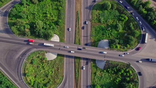 Traffic Driving Over Roundabout with Highway Road Underneath