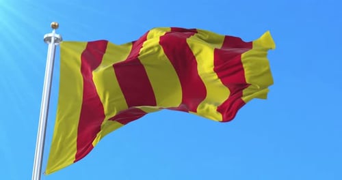 Realistic Red and Yellow Striped Flag Waving in Blue Sky