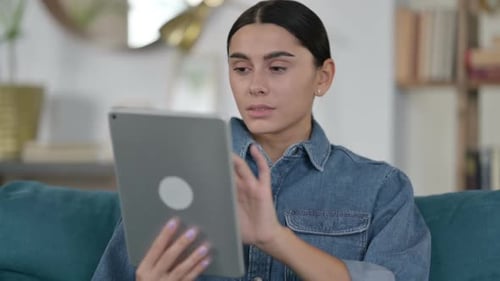 Young Woman Using Tablet Device Close Up Indoors